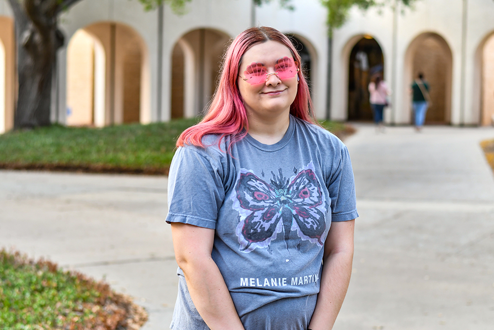 female student outside with rose-colored glasses